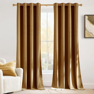 Pair of golden brown velvet grommet top curtains hung on a gold rod, enhancing a bright living room window.