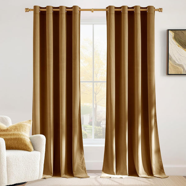 Pair of golden brown velvet grommet top curtains hung on a gold rod, enhancing a bright living room window.