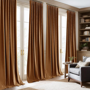 Rich golden-brown velvet pinch-pleat drapes flowing to the floor in a sunlit living room.