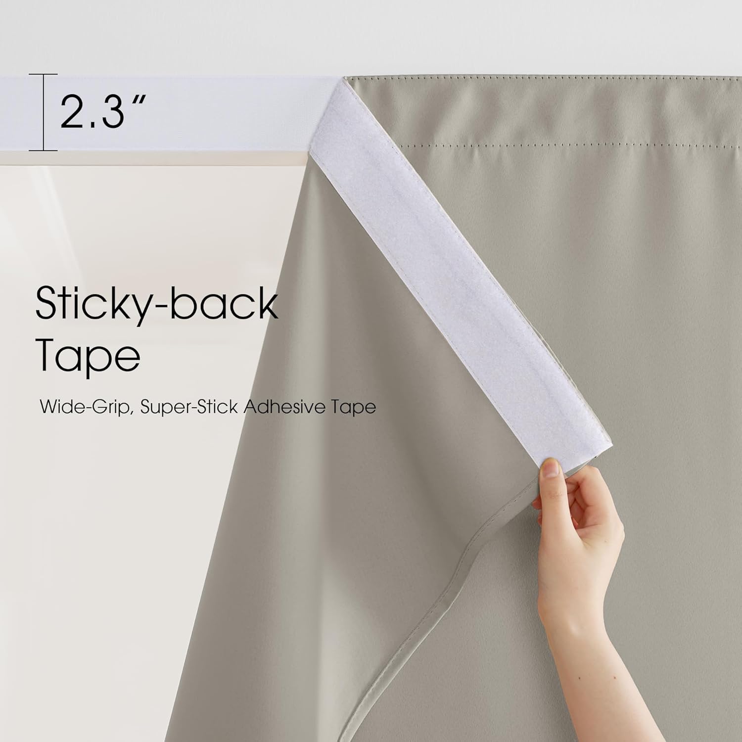 Hand demonstrating the 2.3-inch wide sticky-back tape on a gray blackout curtain panel.
