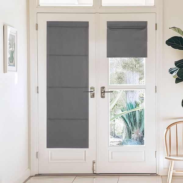 Dark gray blackout shades on white french doors, one long panel, one short rolled-up. Offers privacy and light control.