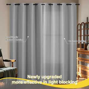 Light gray blackout curtains with grommet tops hanging, demonstrating superior light-blocking effectiveness.