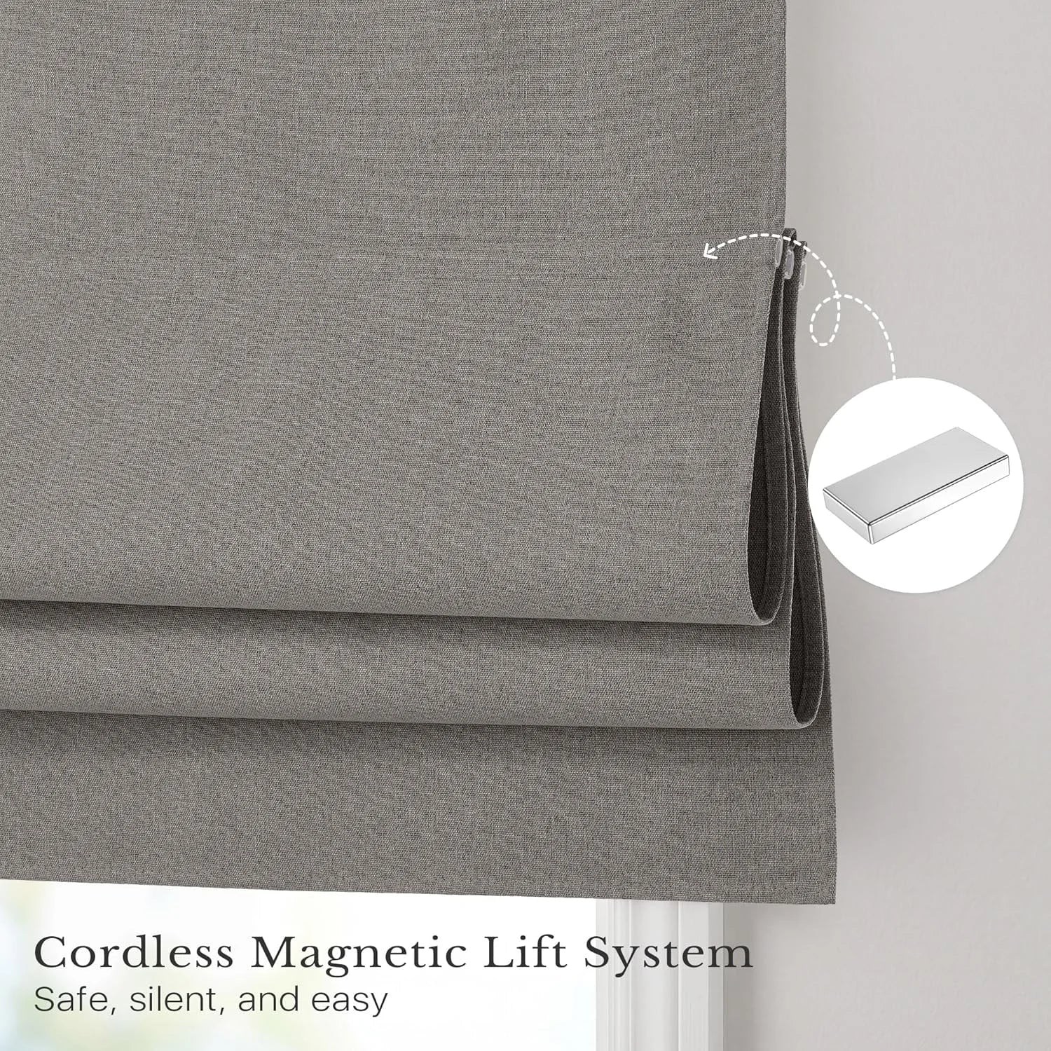Gray fabric roman shade demonstrating cordless magnetic lift system with internal magnets.