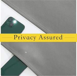 Close-up of gray textured fabric panel blocking light from a green smartphone's flash, highlighting privacy.