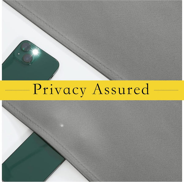 Close-up of gray textured fabric panel blocking light from a green smartphone's flash, highlighting privacy.
