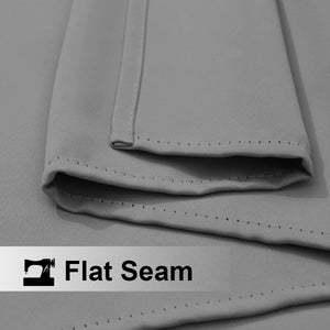 Close-up of light gray fabric with a clean, precisely stitched flat seam visible along the edge.