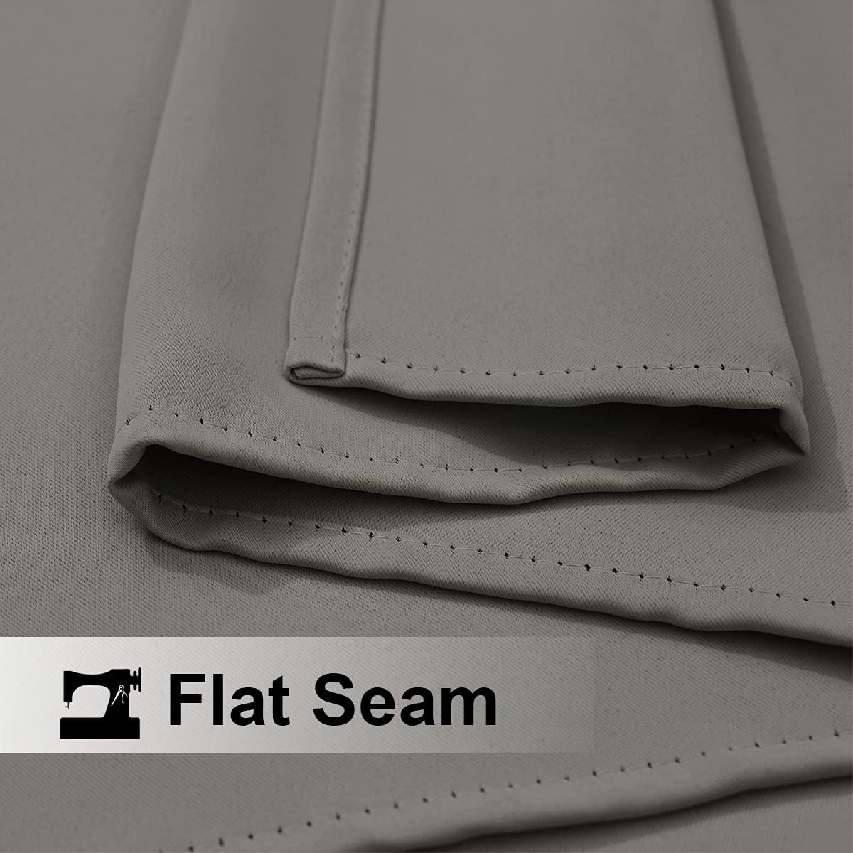 Close-up of light gray fabric with a prominent, neatly stitched flat seam detail.