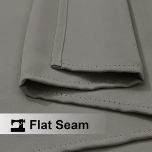Close-up of light gray fabric with a prominent, neatly stitched flat seam detail.