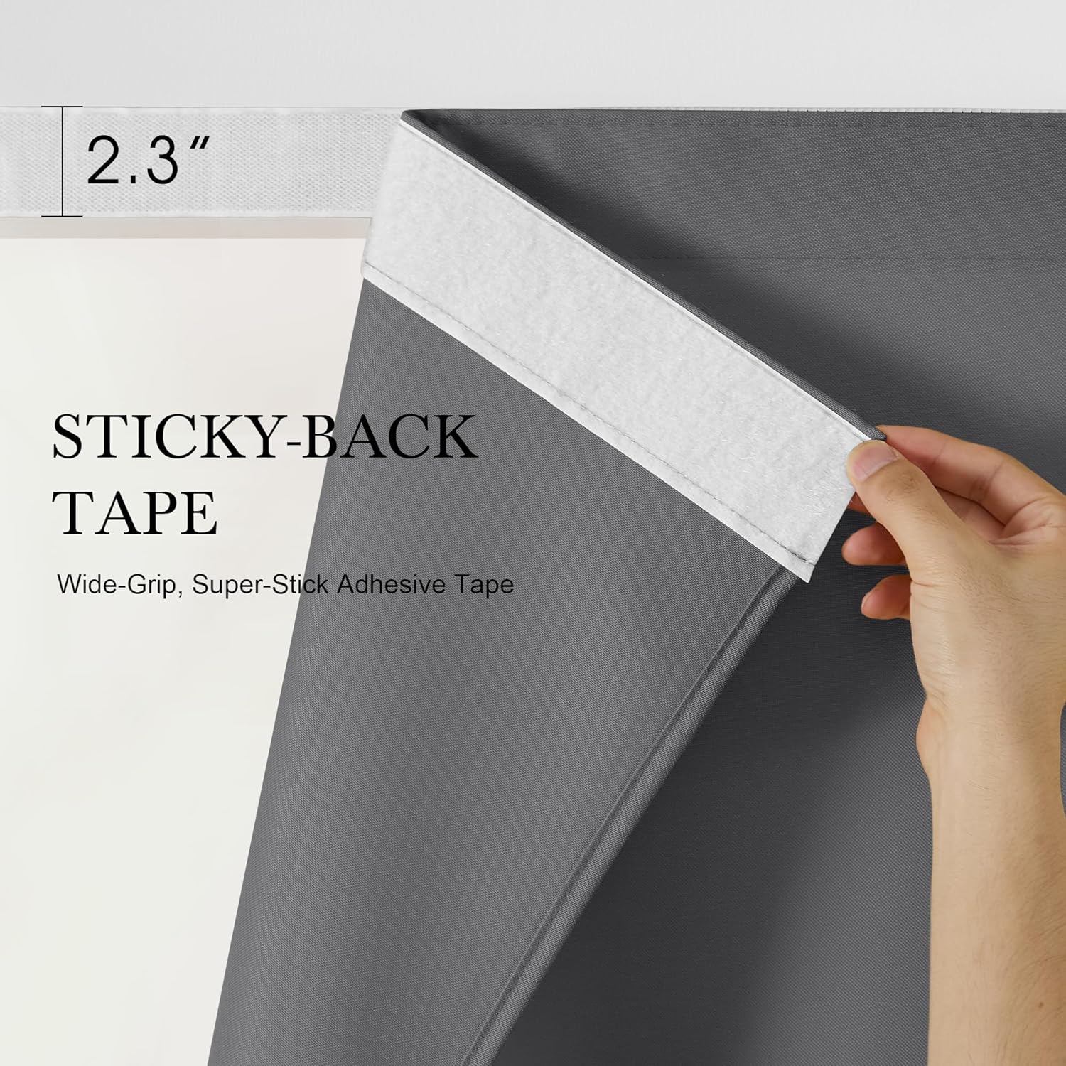 Hand applying 2.3 inch wide white sticky-back adhesive tape to gray fabric, showing its strong grip for versatile use.