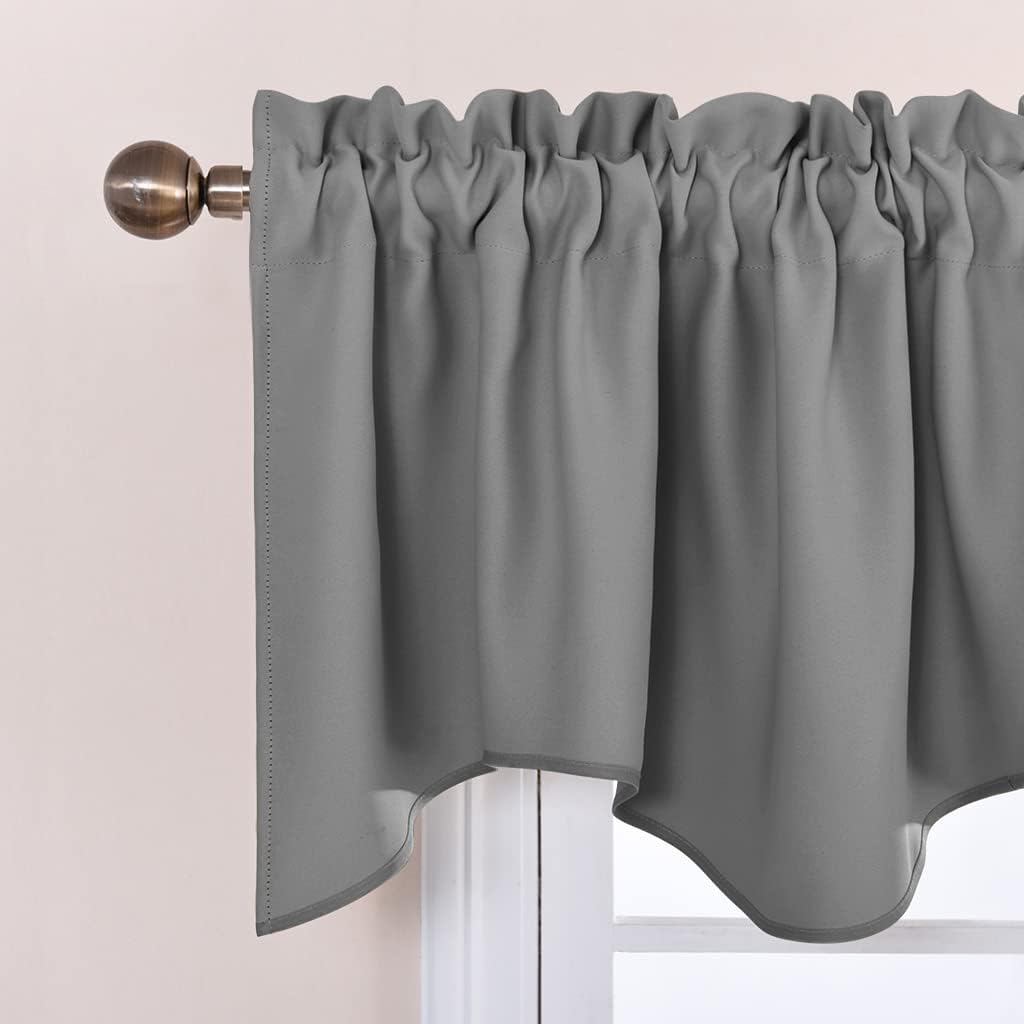 Neutral gray smooth valance with gathered top and scalloped bottom, hanging on a decorative bronze curtain rod.