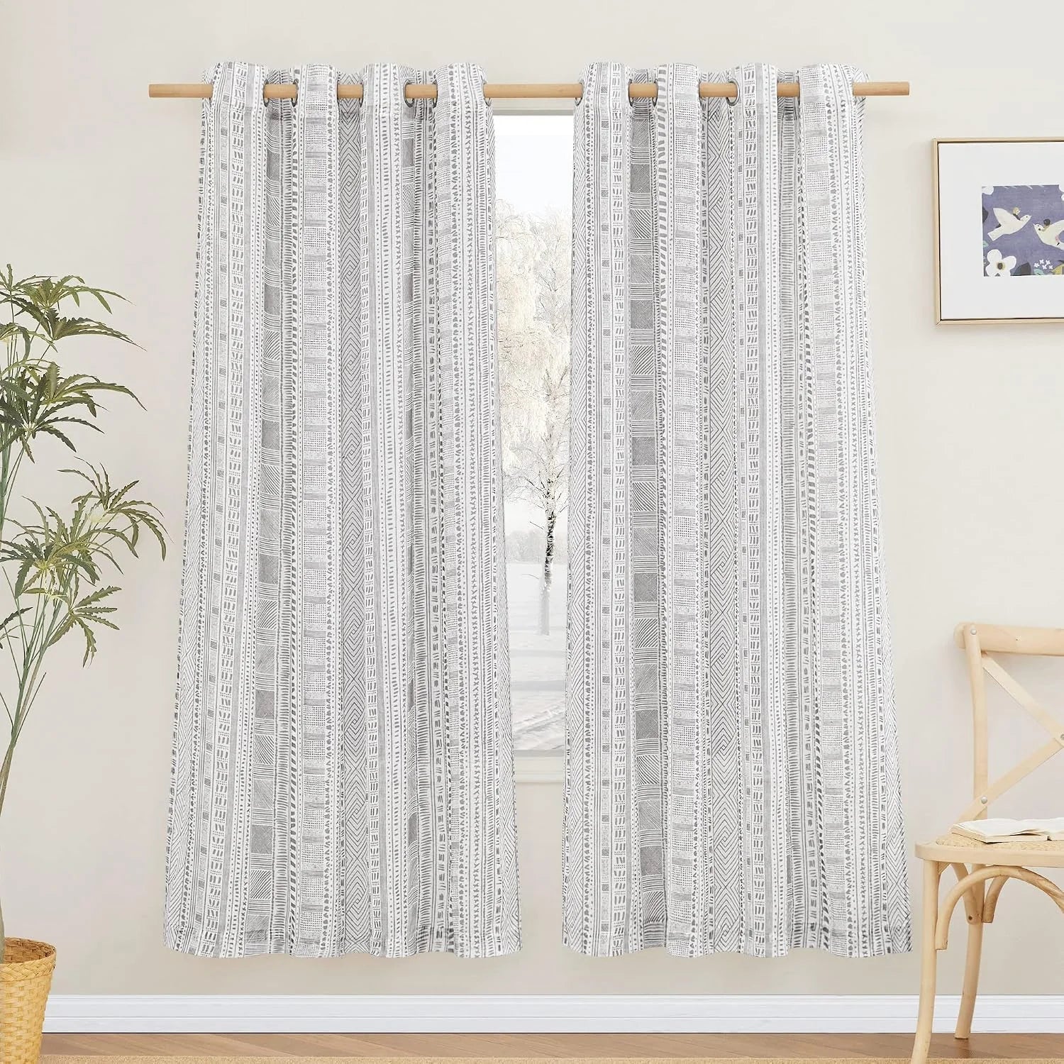 Gray and white geometric rod pocket curtains hanging on a natural wood curtain rod