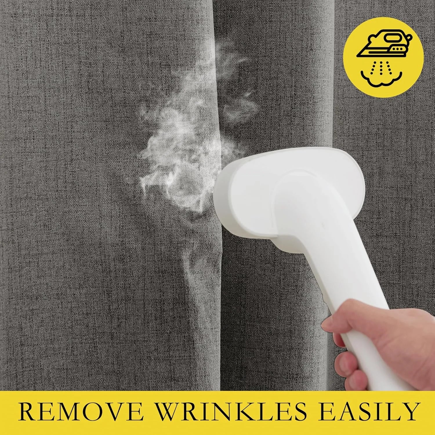 Handheld garment steamer removing wrinkles from gray linen-look curtain panel