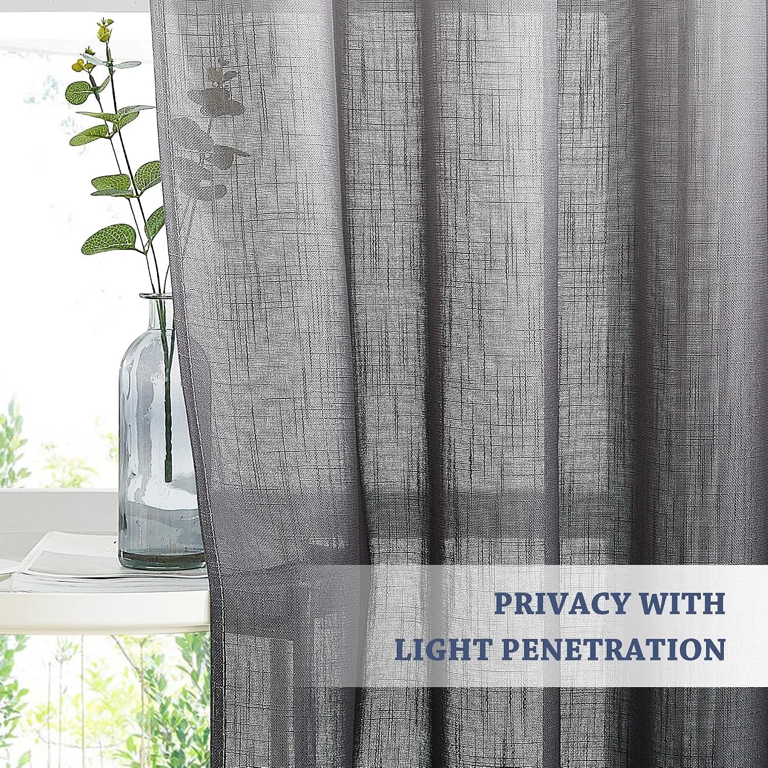 Gray linen-look sheer curtain filtering light by a bright window with vase