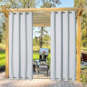 Light gray outdoor curtains with top and bottom grommets on a wooden pergola.