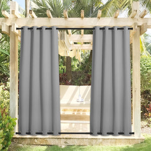 Gray outdoor privacy curtains with black grommets at top and bottom, hanging on a wooden pergola.