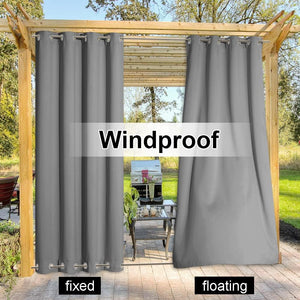 Two gray windproof outdoor curtains with grommet tops on a wooden pergola, showing fixed and floating panels.