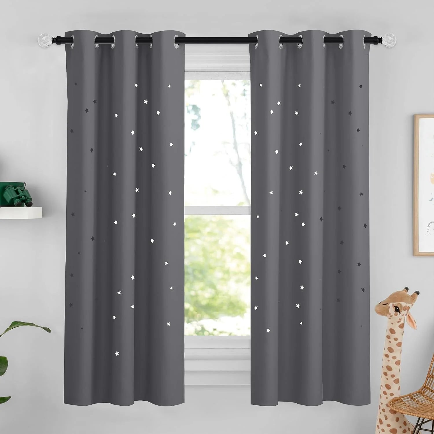 Gray star-pattern blackout curtains with silver grommets in a bright kids room