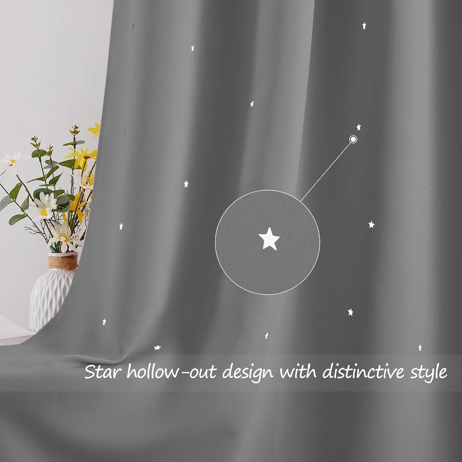 Gray curtain with white star cutout pattern draped beside a vase of flowers