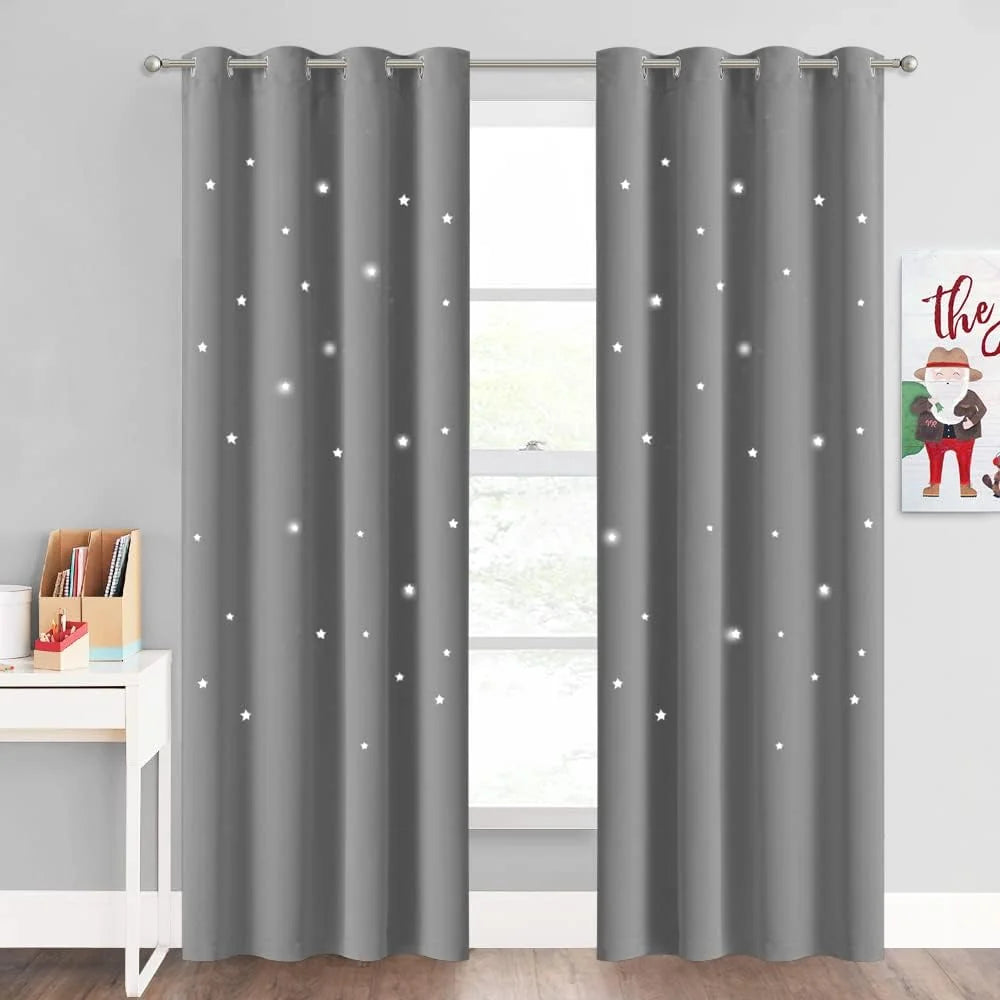 Gray blackout curtains with glowing star cutout pattern in a kids bedroom window