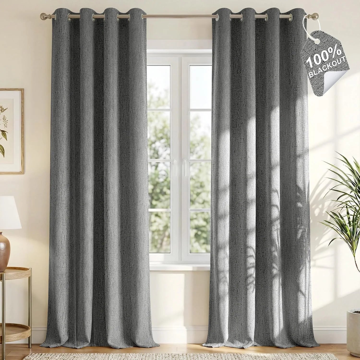 Gray textured blackout curtains with silver grommets hanging in a bright modern room