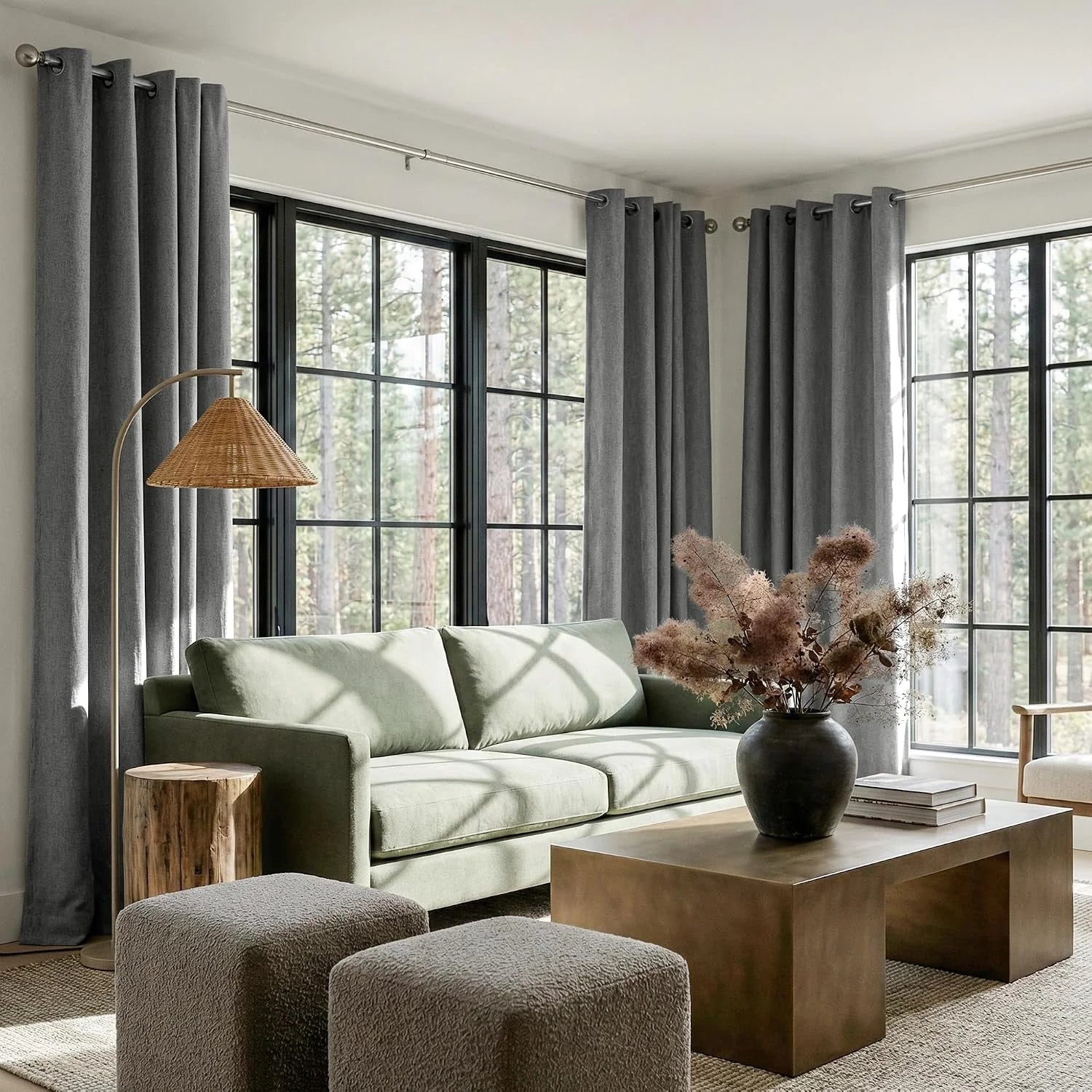 Gray textured grommet curtains in a modern living room with black framed windows