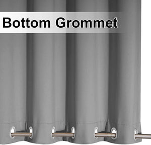 Close up of a gray thermal blackout curtain panel with metallic grommets along the bottom edge.