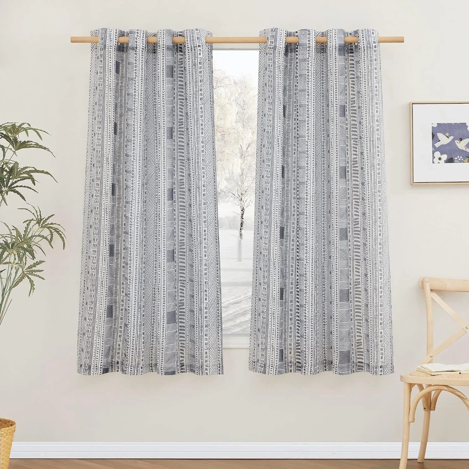 Gray and white tribal print curtains with rod pocket hanging in a bright room
