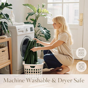 Blonde woman loading dark green fabric into white washing machine, highlighting machine washable and dryer safe.