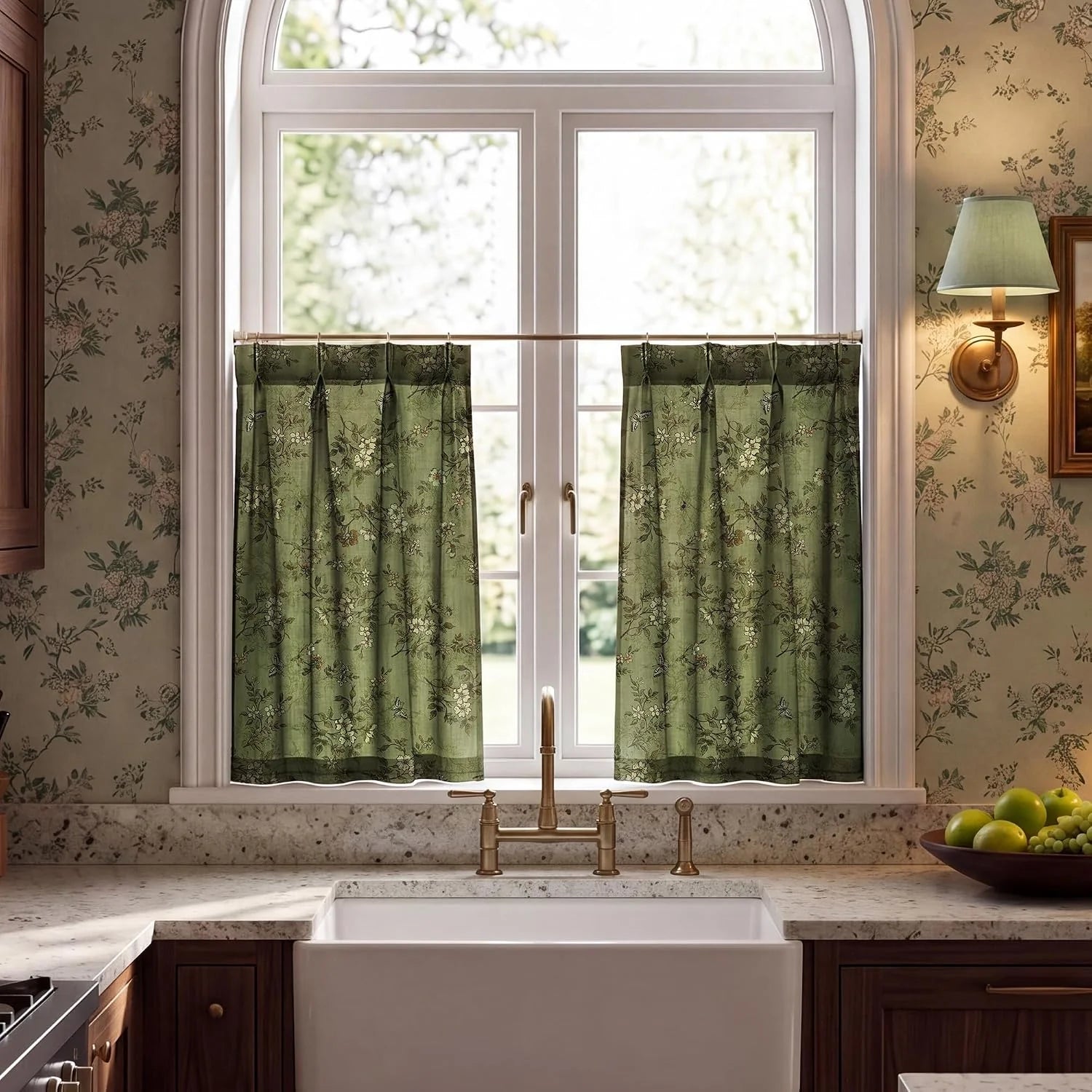 Green floral cafe curtains on an arched kitchen window above a farmhouse sink