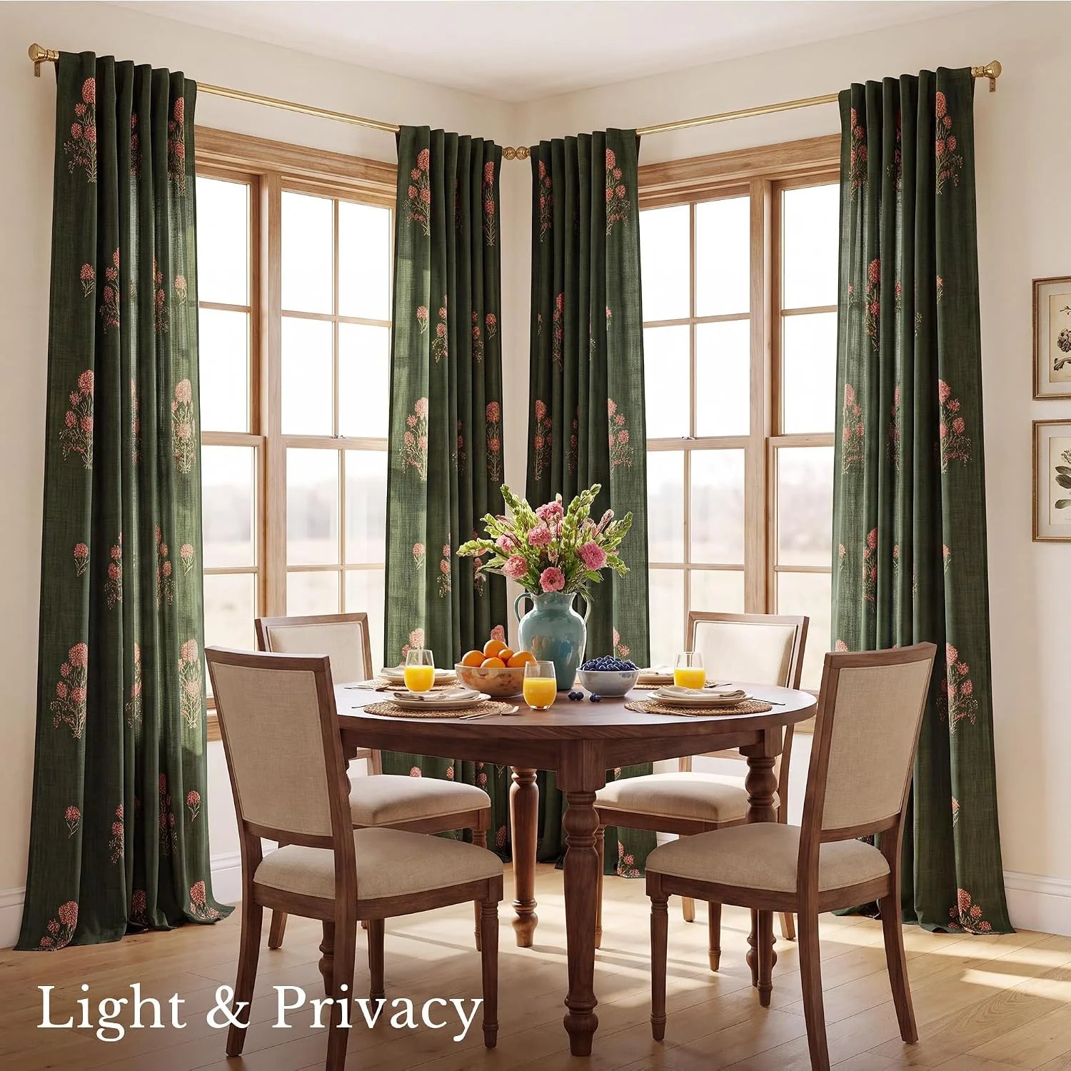 Dark green floral curtains framing bright corner dining room windows
