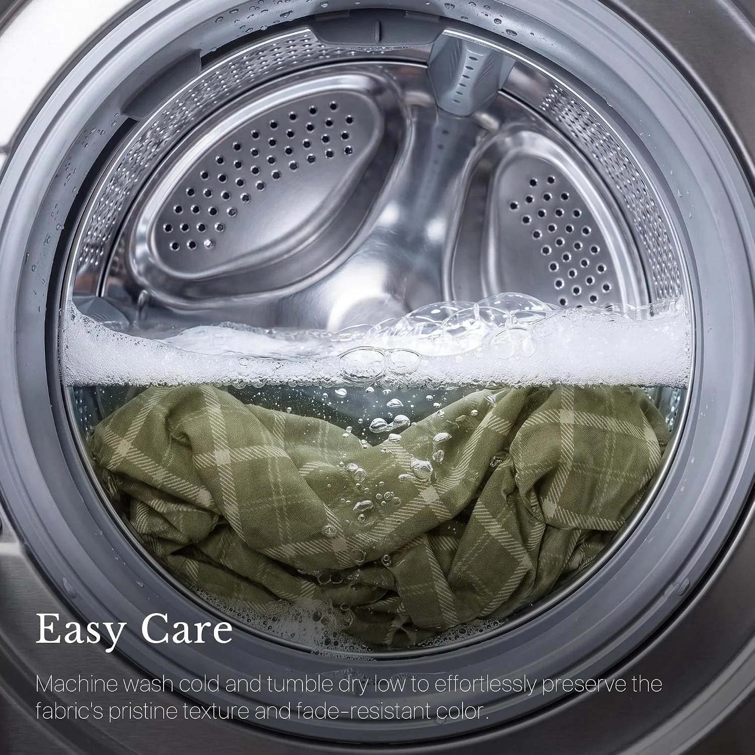 Green plaid fabric washing in a front-load machine with suds and water