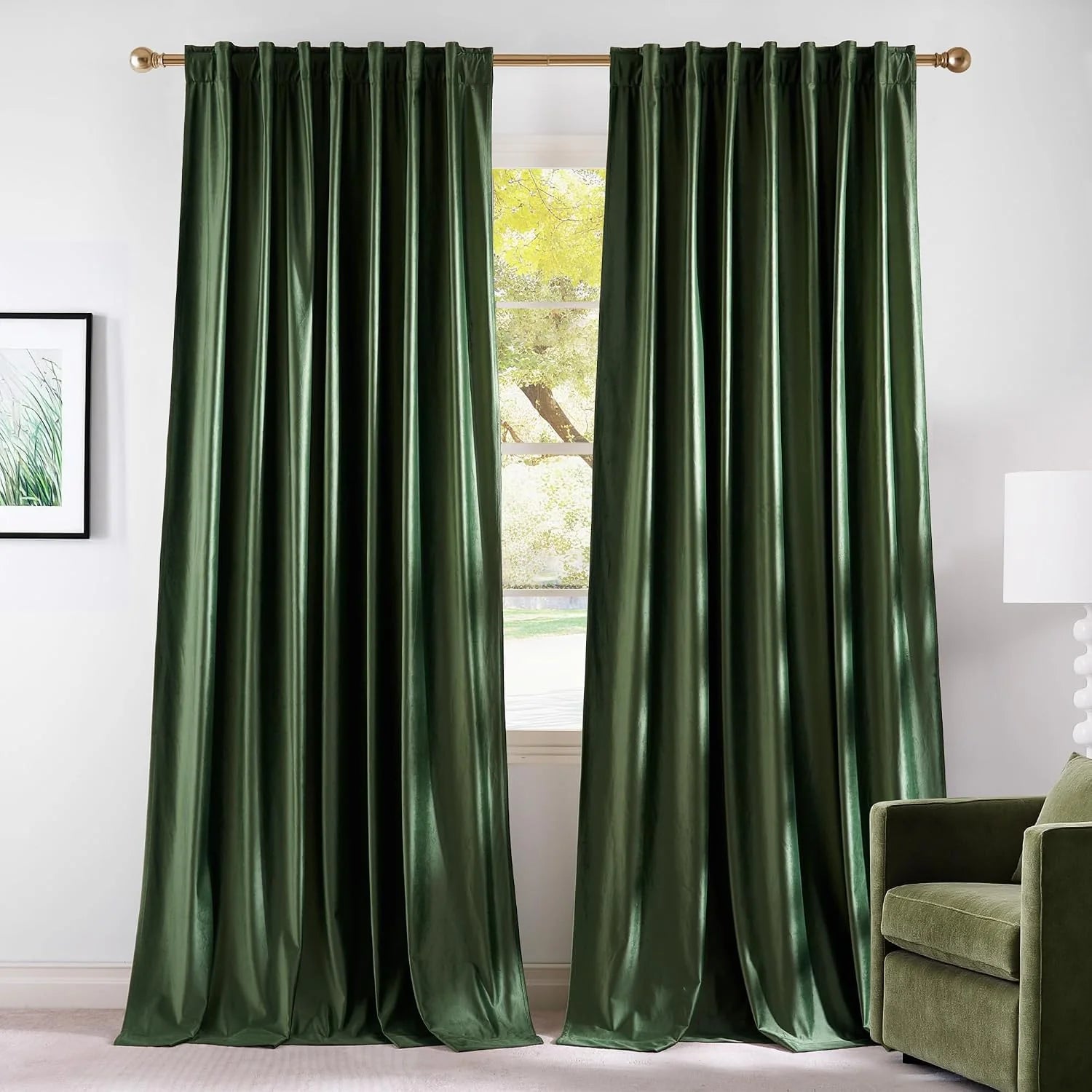 Dark green satin curtains with rod pocket top hanging on a brass curtain rod