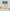 Green and white buffalo check kitchen valance with ruffled rod pocket top above a sink.