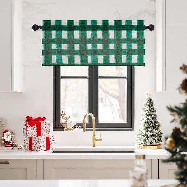 Green and white gingham plaid kitchen window valance hung on a black rod, visible over a sink.