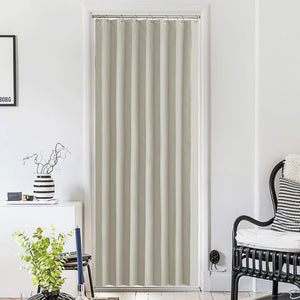 Full-length greige pleated blackout doorway curtain with metal rings, providing privacy in a white-walled room.
