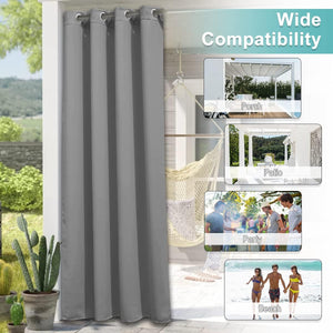 Grey outdoor curtain panel with silver grommet top hanging on a patio, providing shade and privacy.