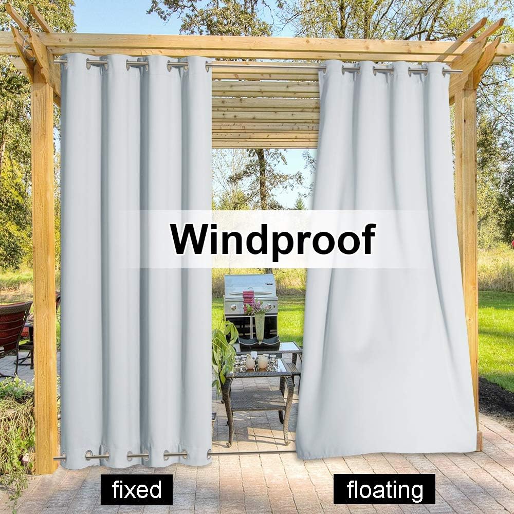 Light grey windproof outdoor patio curtains with grommet tops hanging from a wooden pergola.