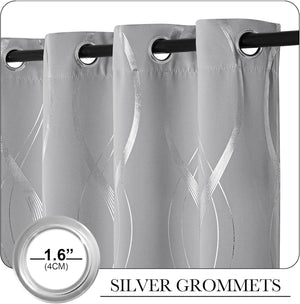Close-up of grey curtains with shimmering silver wavy abstract patterns and large 1.6 inch silver grommets hanging on a black rod.