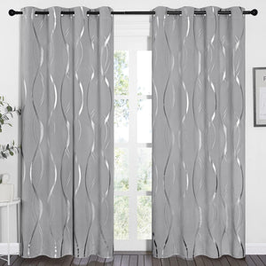 A pair of light grey curtains with metallic silver wavy patterns, featuring black grommet tops.