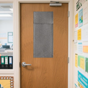 Dark grey textured fabric panel covering a window on a wooden office door for privacy.