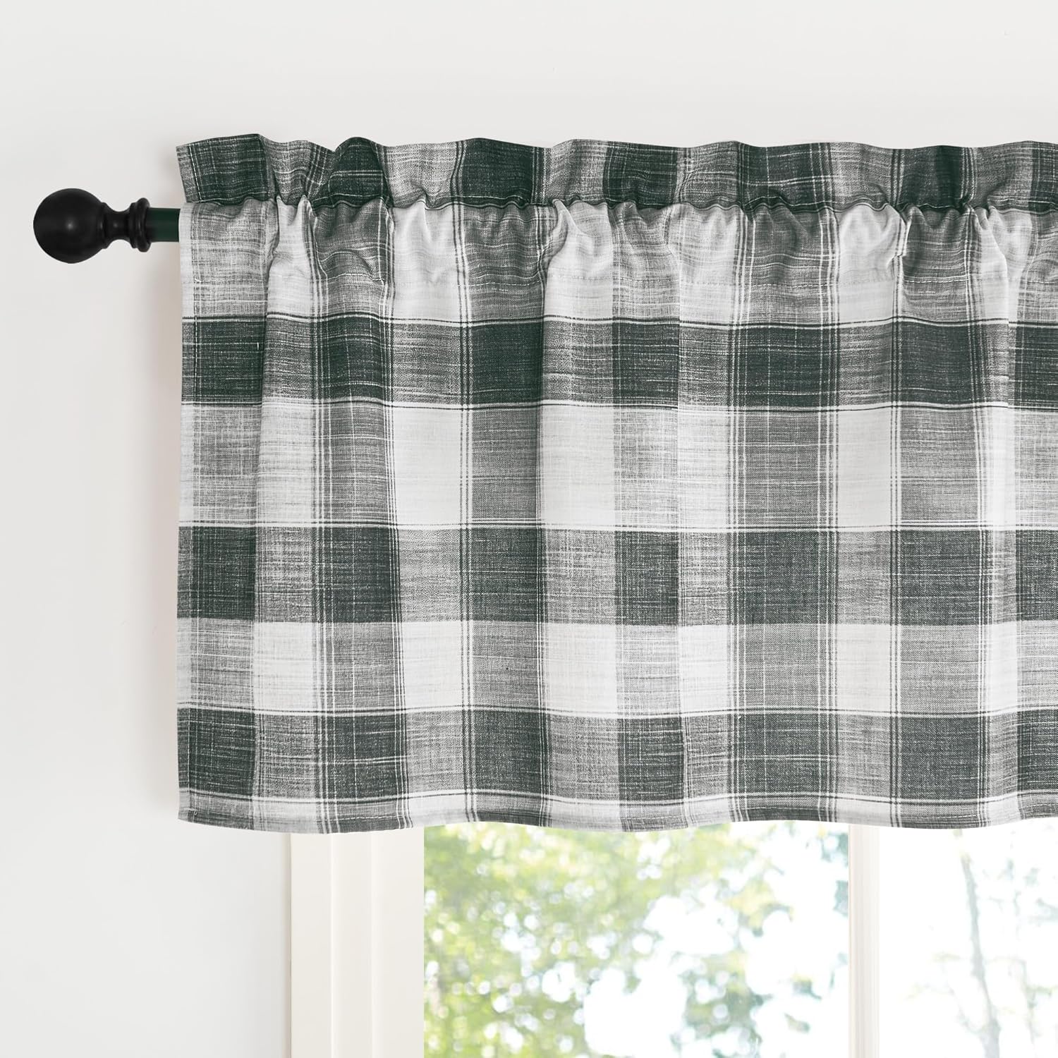 Hunter green and white plaid window valance with rod pocket design, hanging on a black curtain rod.