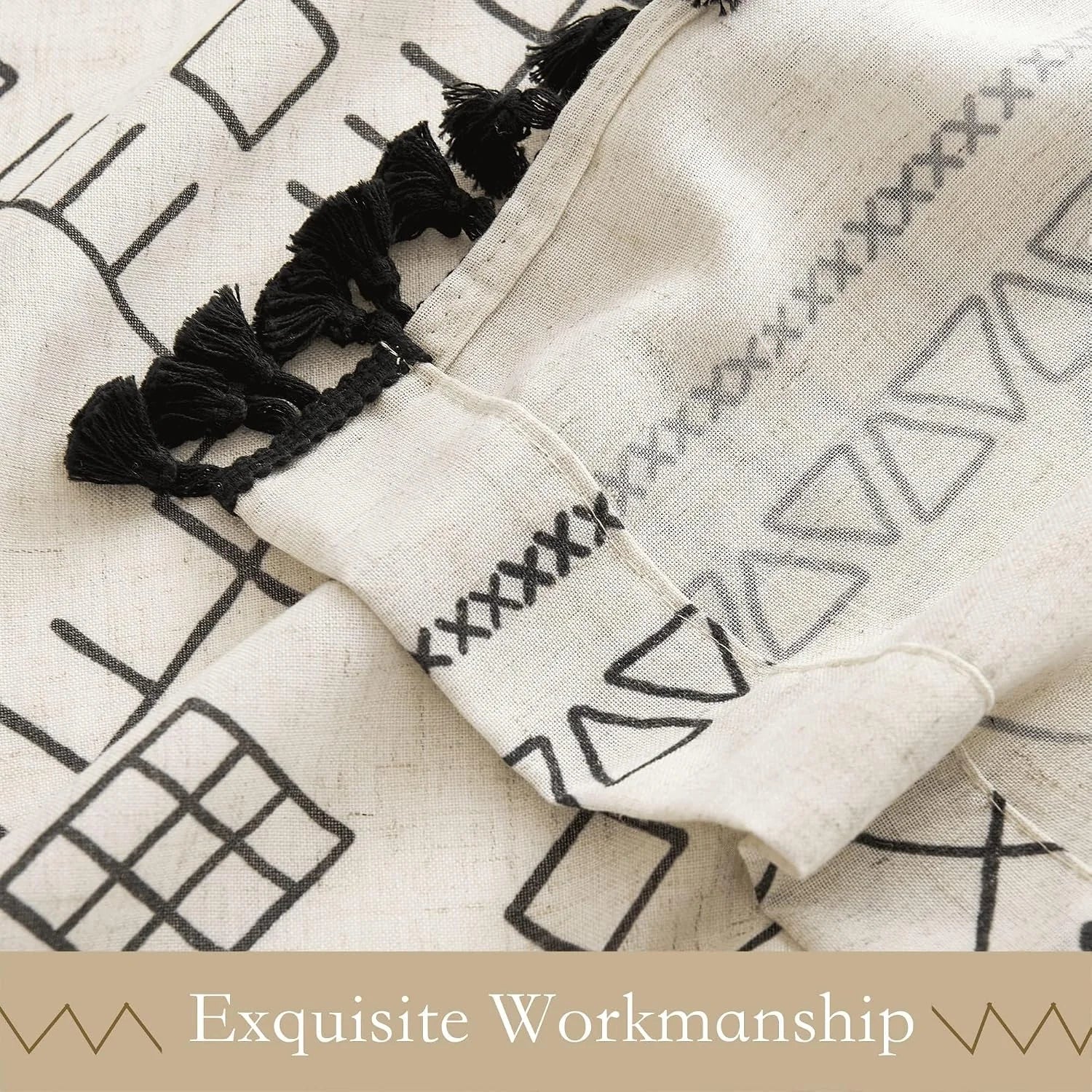 Ivory cotton throw blanket with black geometric print and tassel trim detail