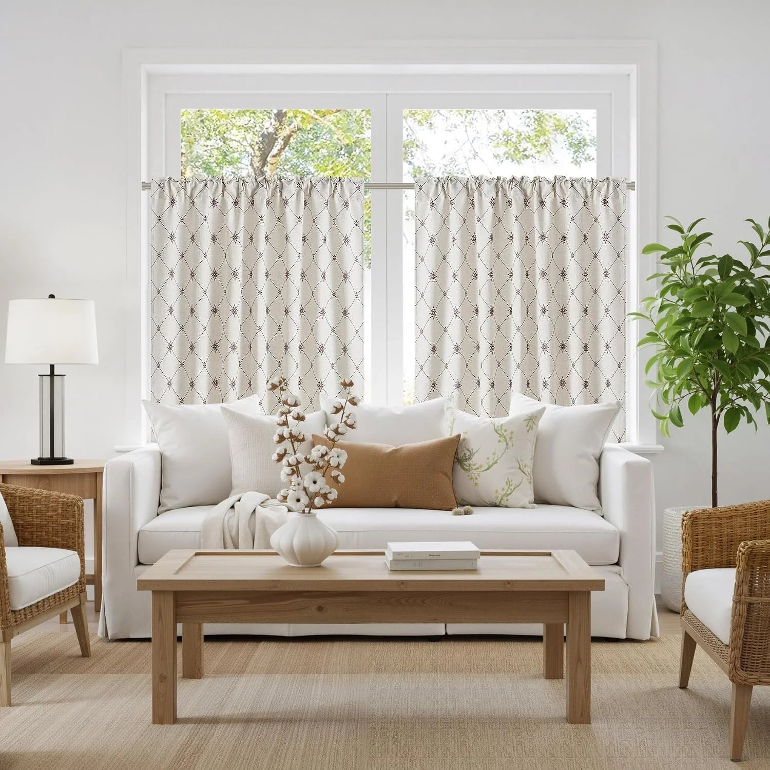 Ivory geometric cafe curtains on a bright window in a cozy neutral living room