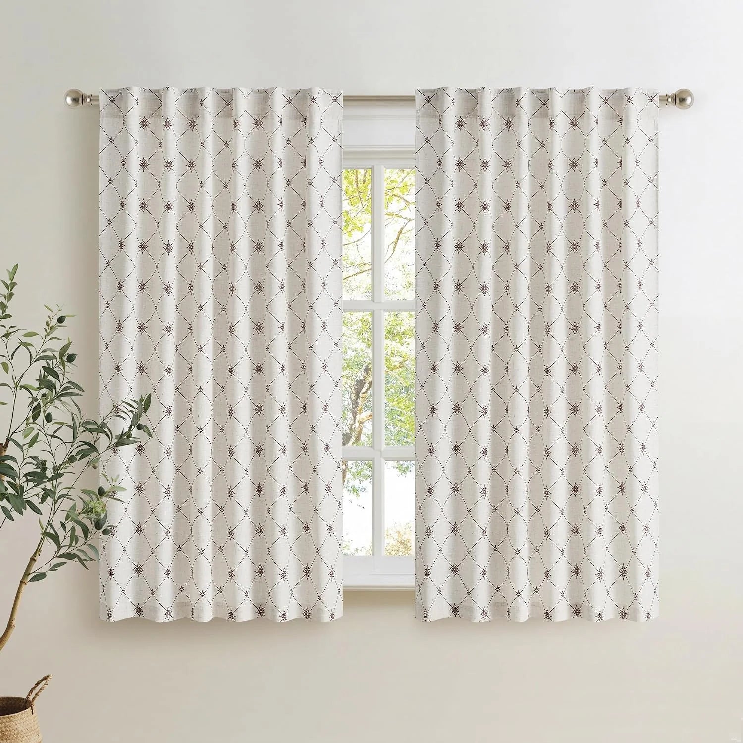 Ivory linen-look curtains with brown geometric lattice pattern on a bright window