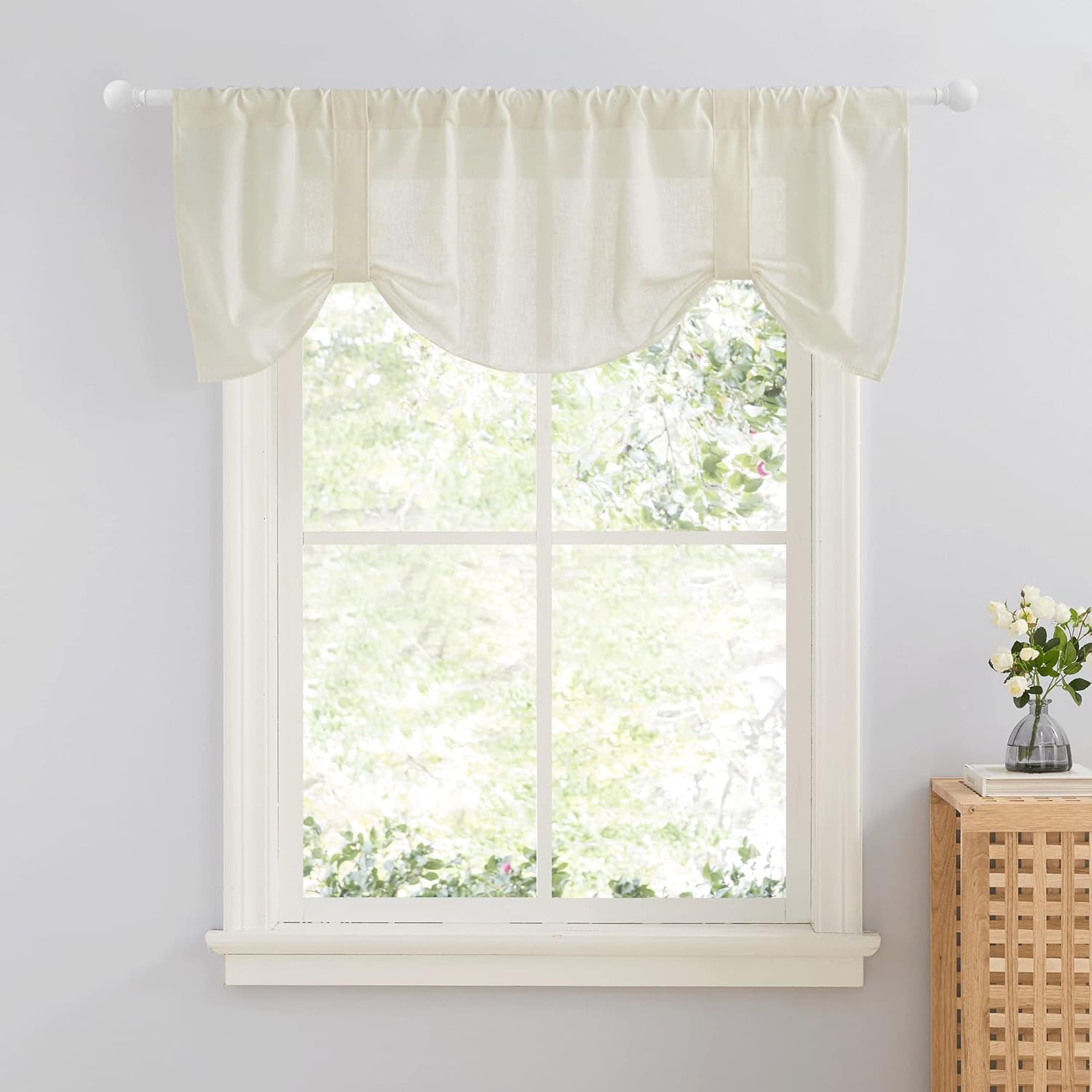 Ivory linen blend tie-up valance with gathered fabric creating an arched design, hung over a window.