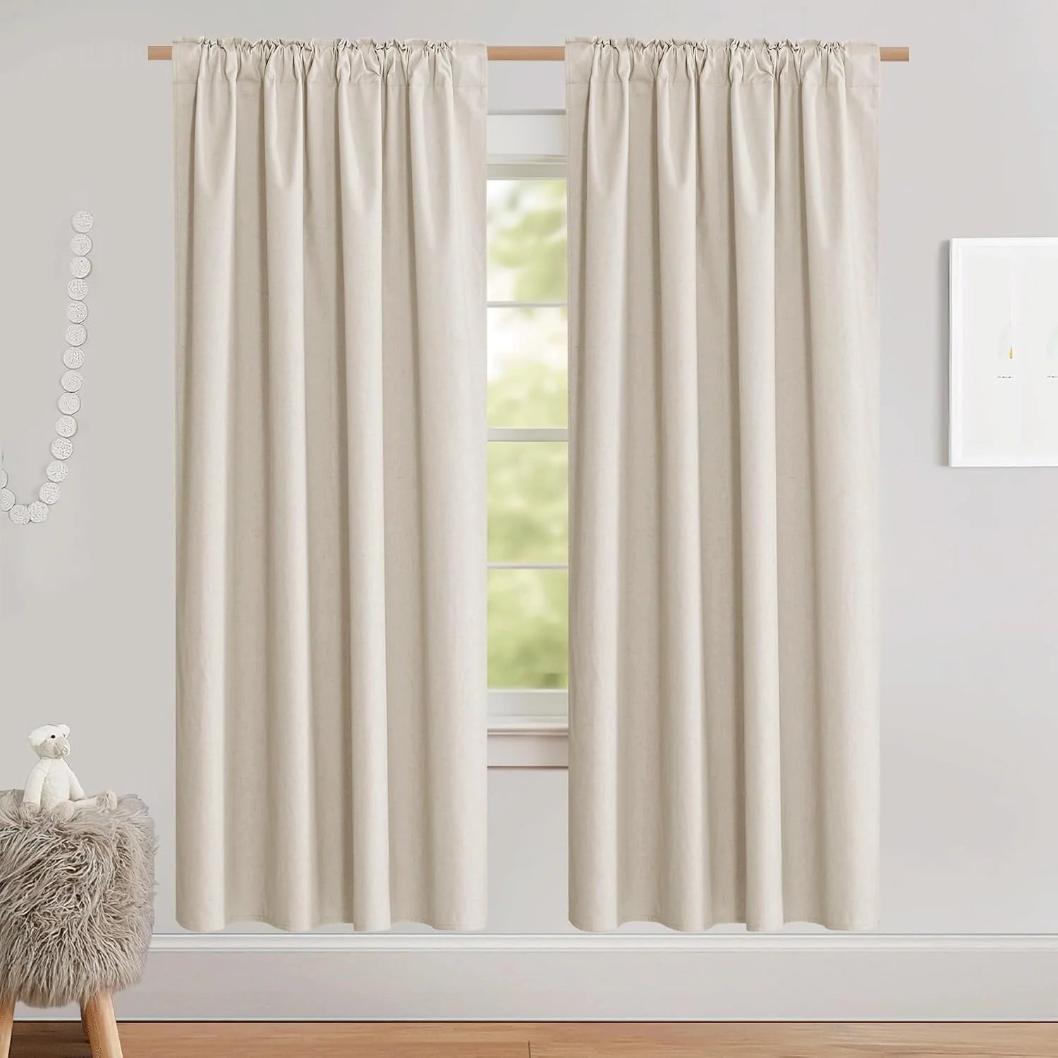 Ivory linen-look rod pocket curtains hanging in a soft neutral bedroom or nursery