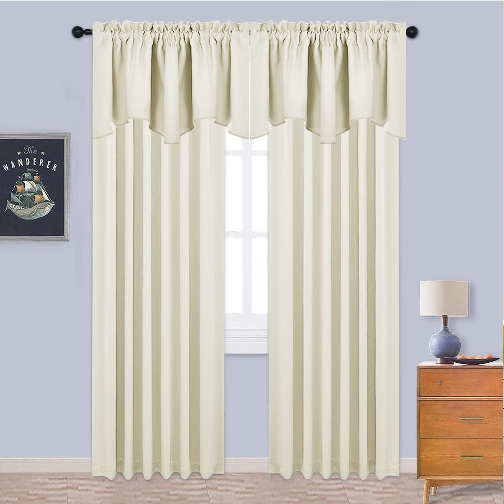 Ivory rod pocket blackout curtains and matching scalloped valance over a bright window.