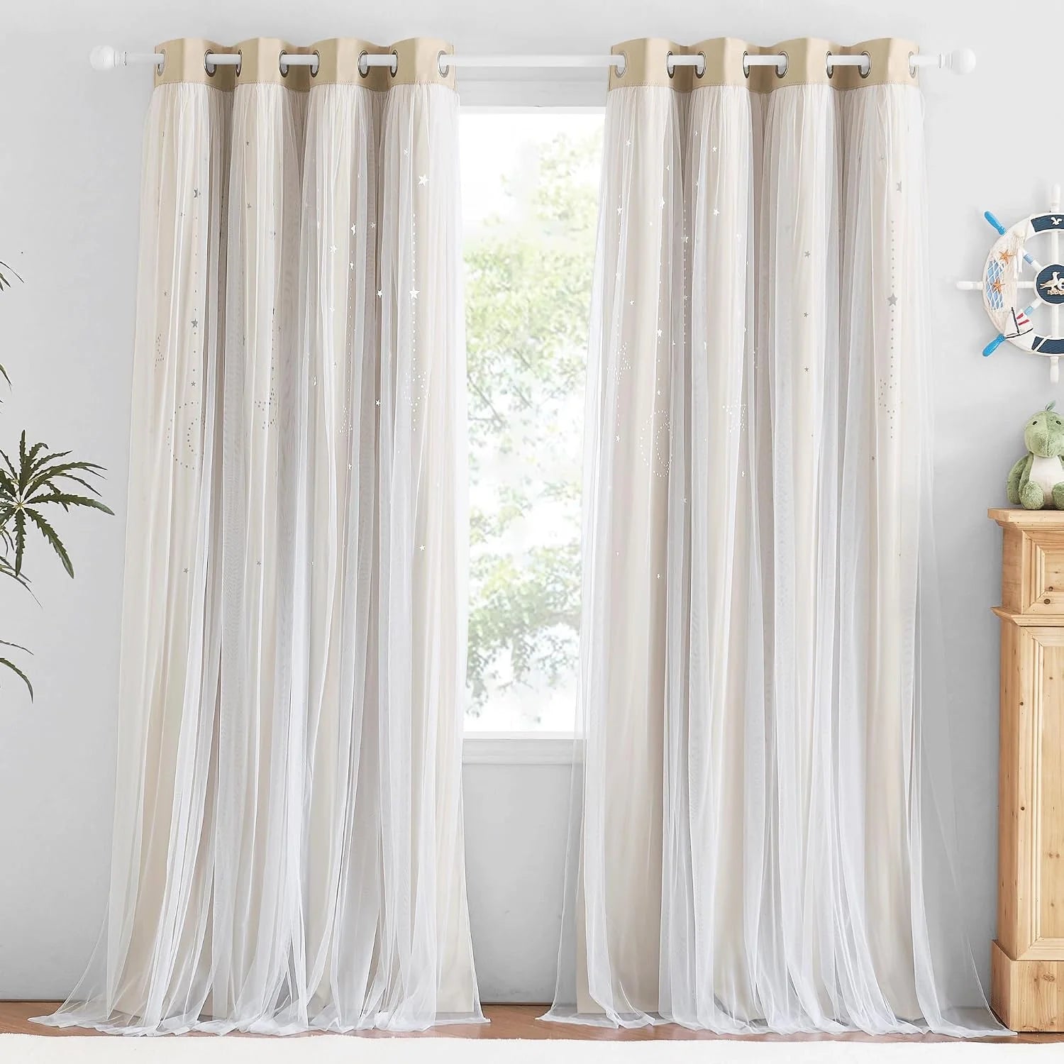 Ivory sheer curtains with silver star details and grommet top in a bright kids room