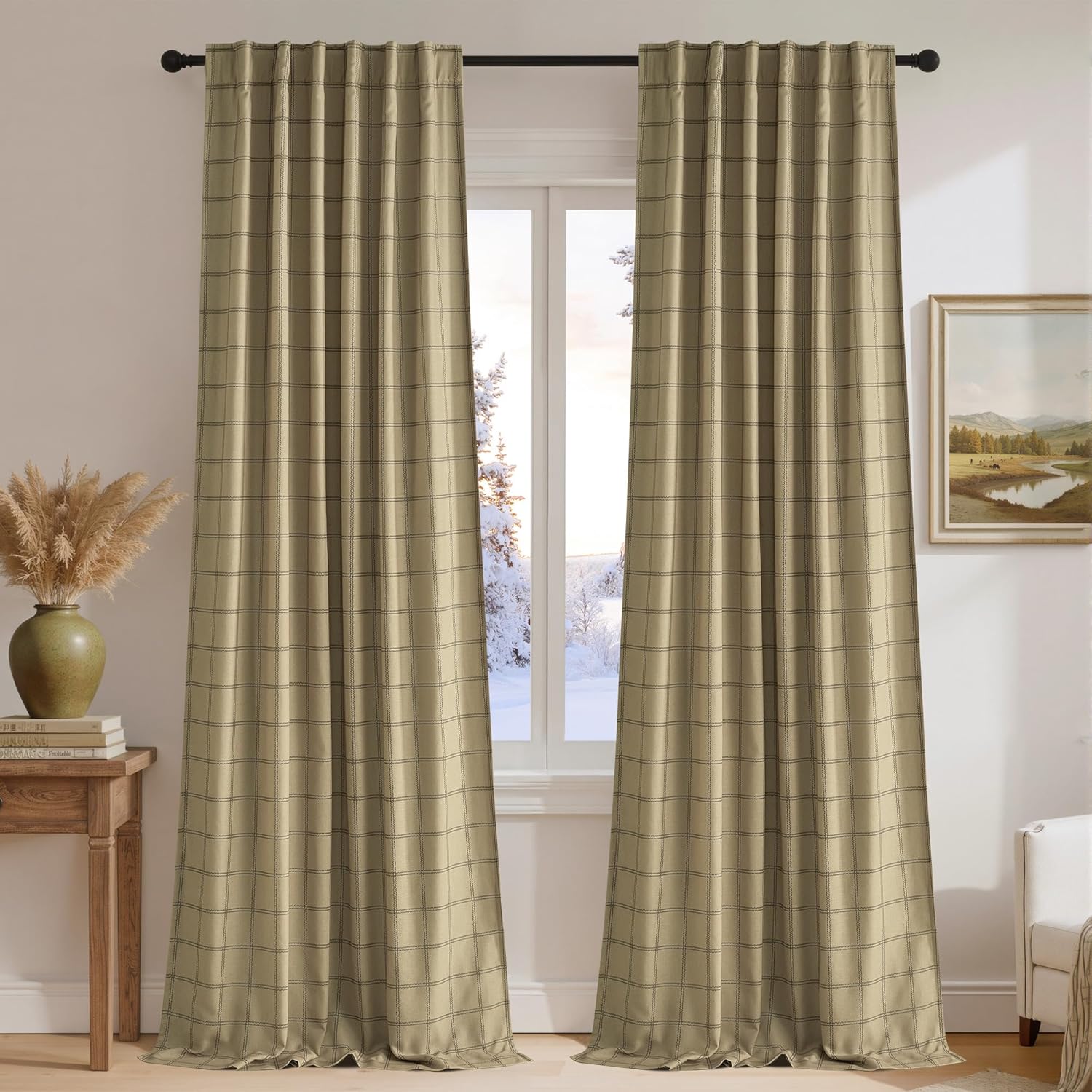 Pair of khaki plaid back tab window curtains with a black grid pattern, hung over a snowy window.