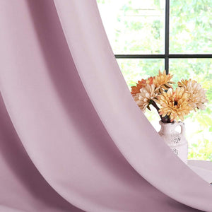 Soft lavender room darkening curtain drapes. Window with green foliage and flower vase visible.